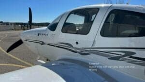 Close-up of the front of a Cirrus SR22 G3 aircraft with a white and gray paint scheme.