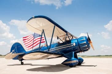 Close up of the wheel fairing of a biplane.