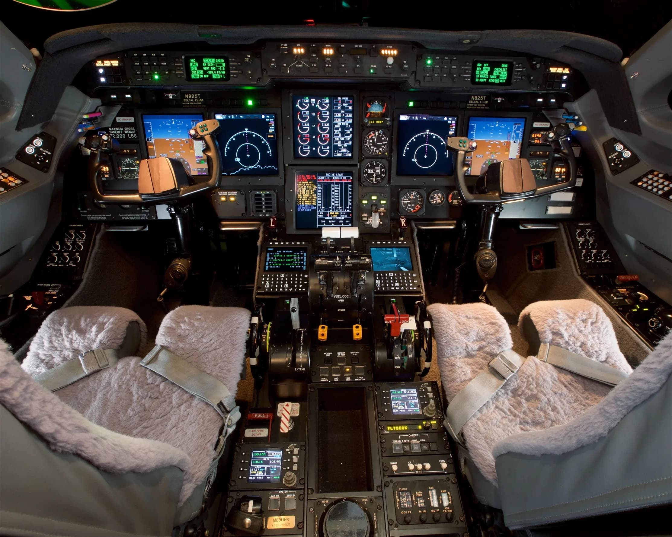 The advanced cockpit of a private jet features multiple digital displays, complex controls, and sheepskin-covered pilot seats.
