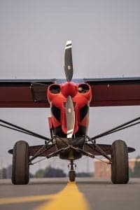 Front view of a red and black Carbon Cub aircraft on the ground.