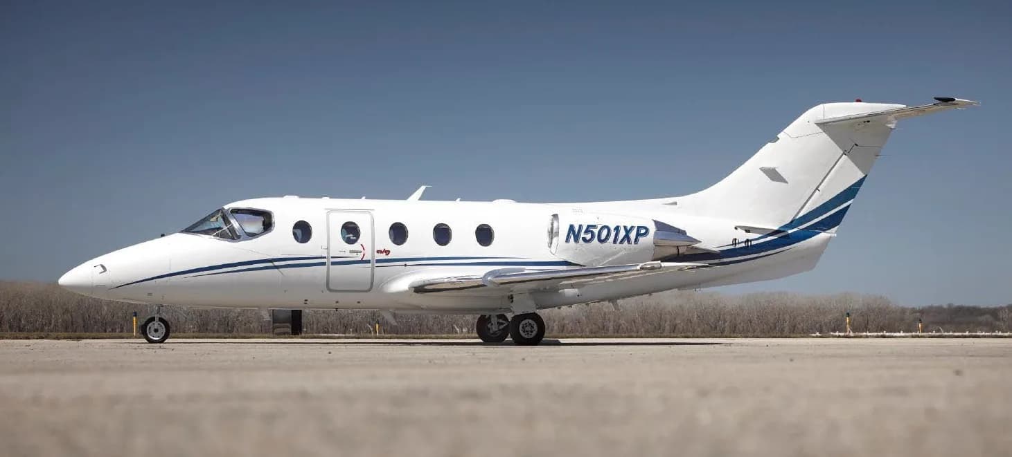 A Hawker 400XP aircraft with registration N501XP parked on the tarmac.