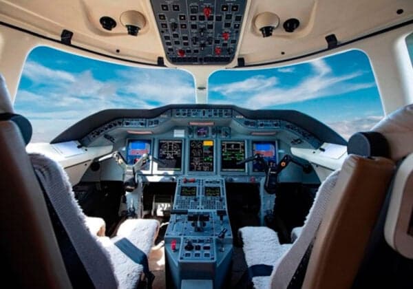 The cockpit of a Hawker jet with a view of the sky.