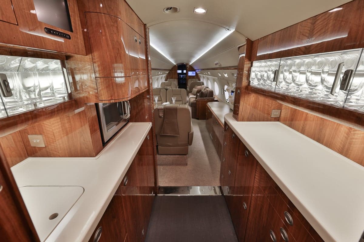 Interior view of the aircraft galley and cabin seating.