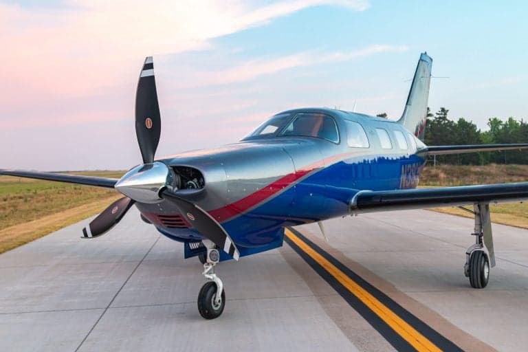 Front quarter view of a Piper Mirage on the runway.