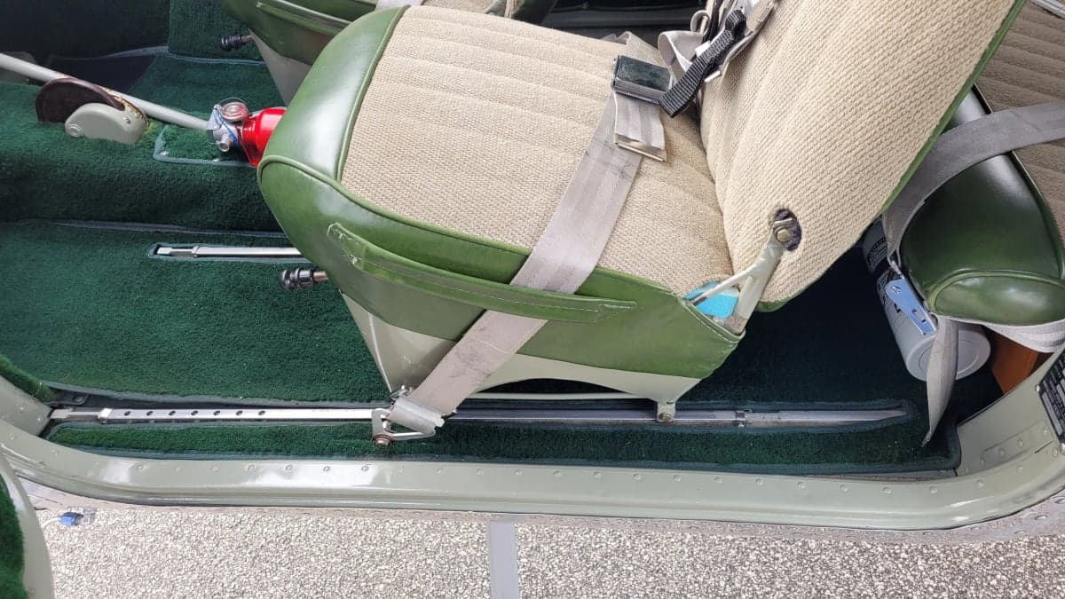 Close-up of the Cessna 170 seat and green carpeting.