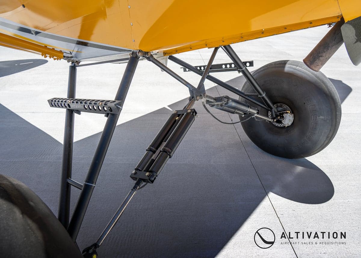 A yellow Carbon Cub aircraft with large tundra tires.