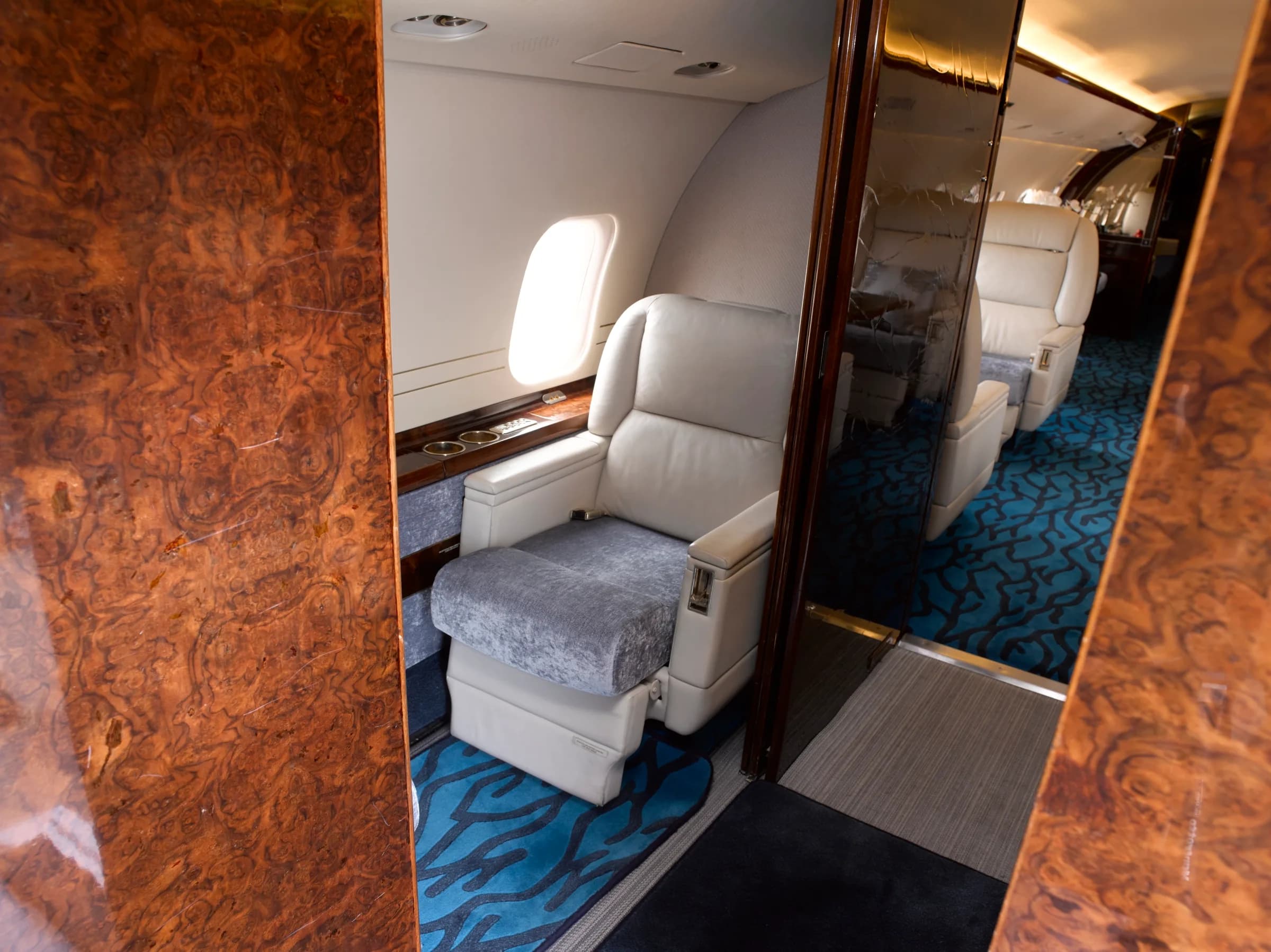 Single seat in the aircraft cabin with wood accents.