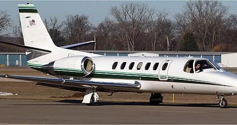 A white and green Cessna Citation CJ1 is shown on the tarmac.