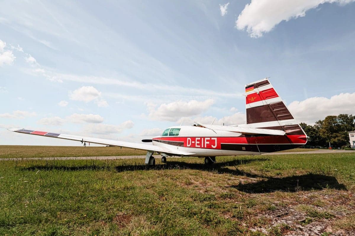 Rear view of Mooney M20J aircraft D-EIFJ on the ground.