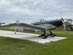 Side view of the gray and black N194PT aircraft on a concrete pad.