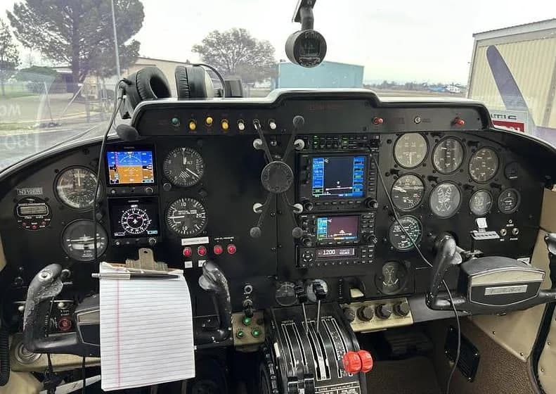 The aircraft's instrument panel featuring a mix of analog gauges and modern digital displays.
