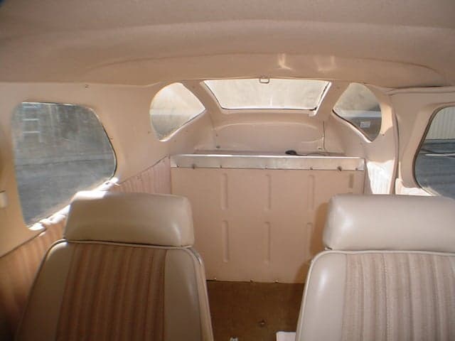The rear interior cabin of a Cessna 206 aircraft, showing the cargo area and rear windows.