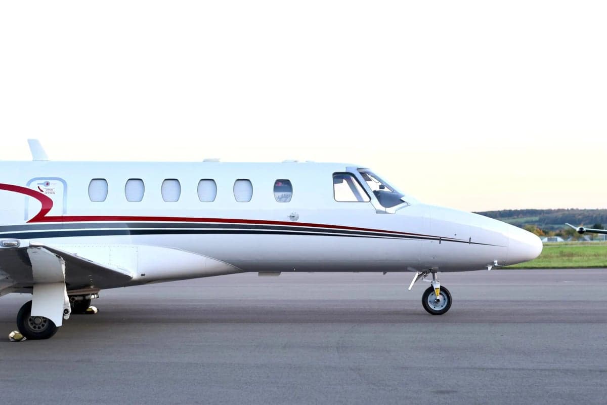 Close-up side view of a Cessna Citation CJ1+ aircraft fuselage.
