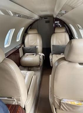 Interior view of the aircraft cabin with leather seats.