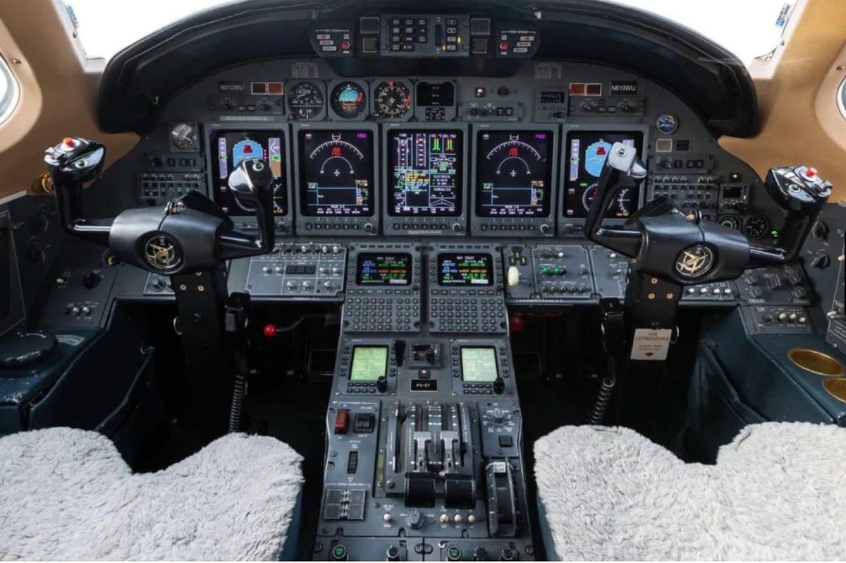 The instrument panel and controls of an aircraft cockpit.