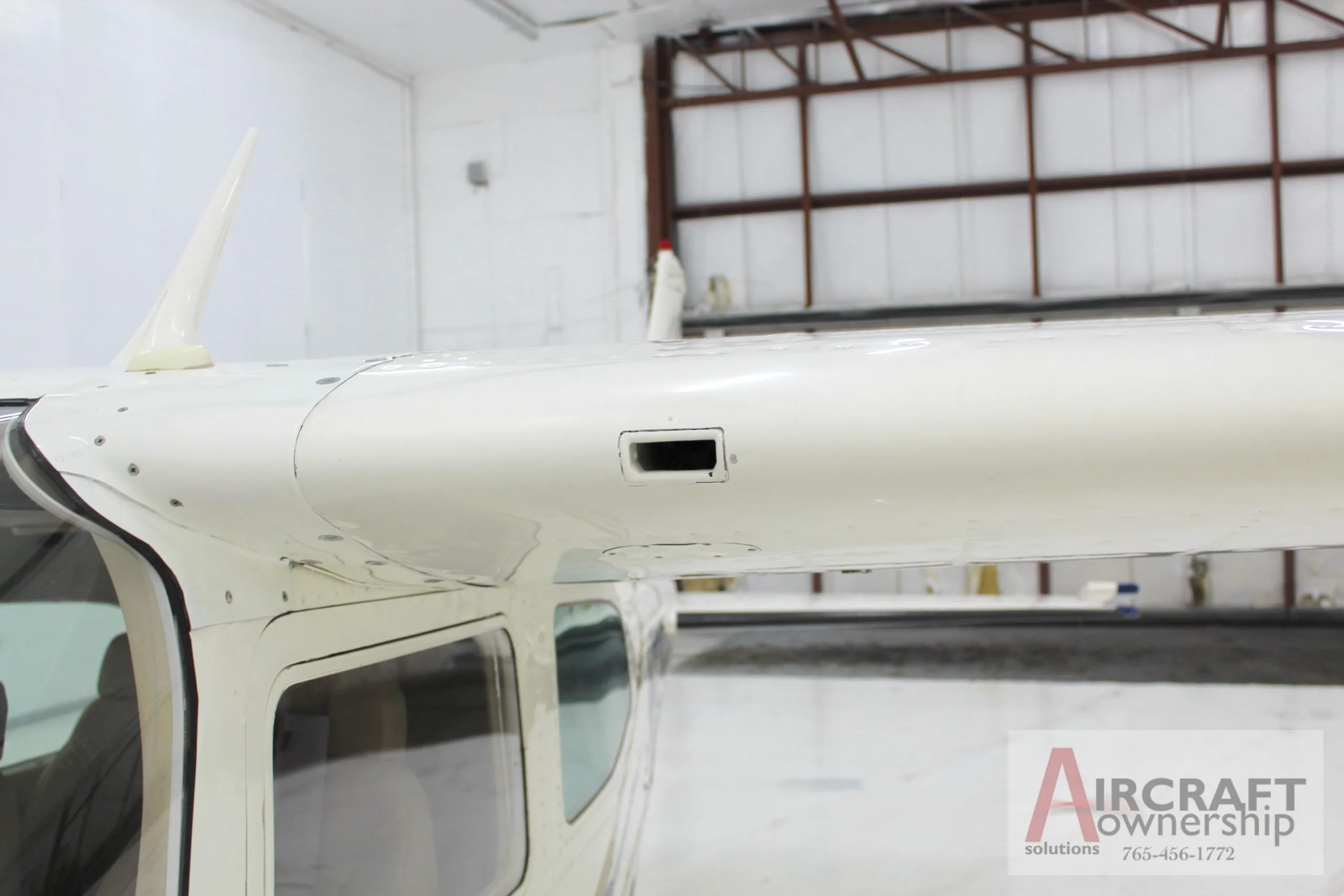 Close-up view of the top of the fuselage and wing root of the Cessna 206 aircraft, N5091V.