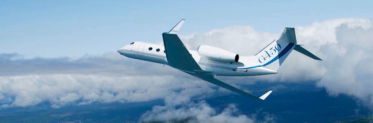 A Gulfstream G450 in flight with a blue and white paint scheme.