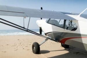 Close up of N864G aircraft on a beach.