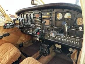 The cockpit of the aircraft features brown seats and a black instrument panel.