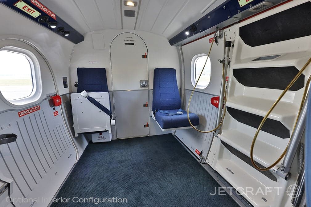 View of the aircraft cabin with blue leather seats and a staircase.