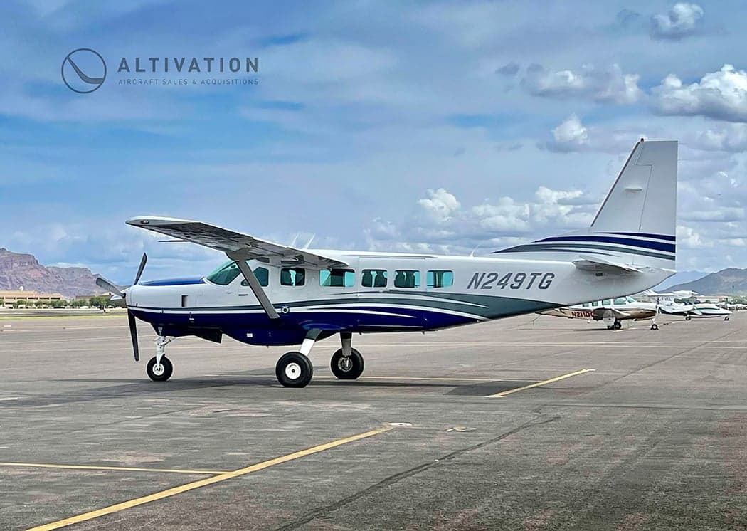 Cessna 208 Caravan, registration N249TG, parked on the tarmac.