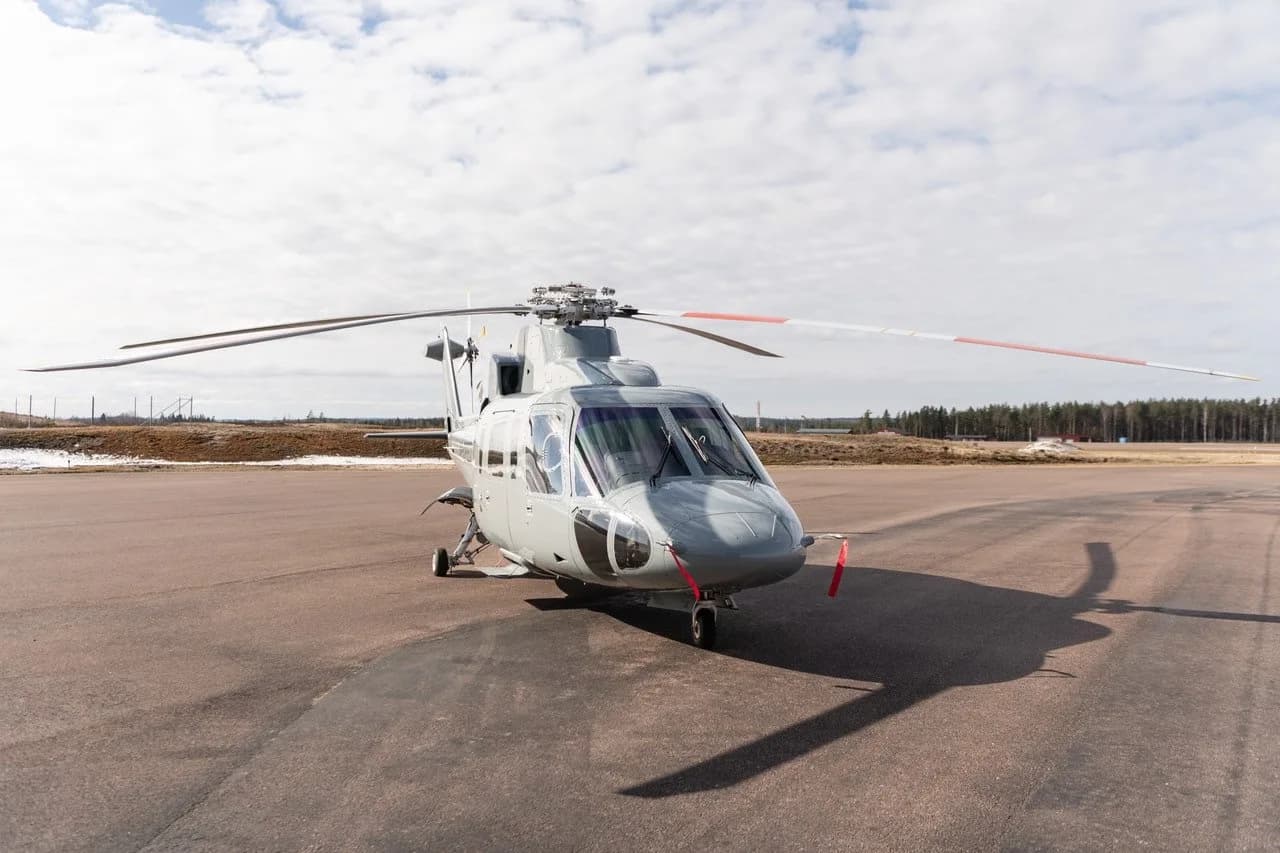 Front view of a gray helicopter parked on the tarmac.