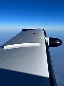 View of the wing of an aircraft in flight.