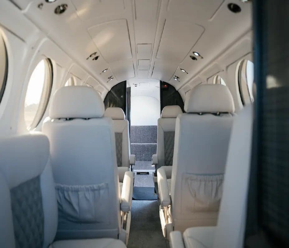 The interior of a King Air B200 aircraft, showing the seating arrangement.