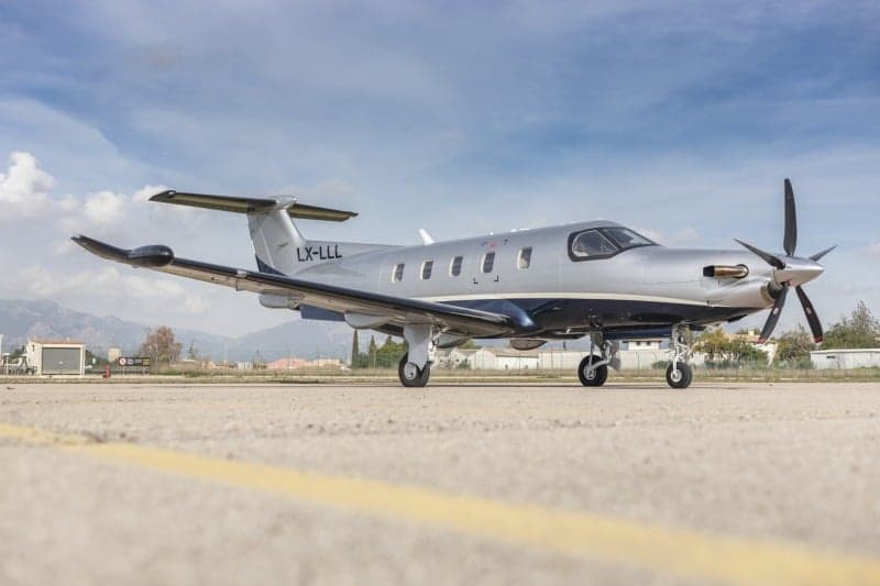 A Pilatus PC-12 aircraft with registration LX-LLL parked on the tarmac.