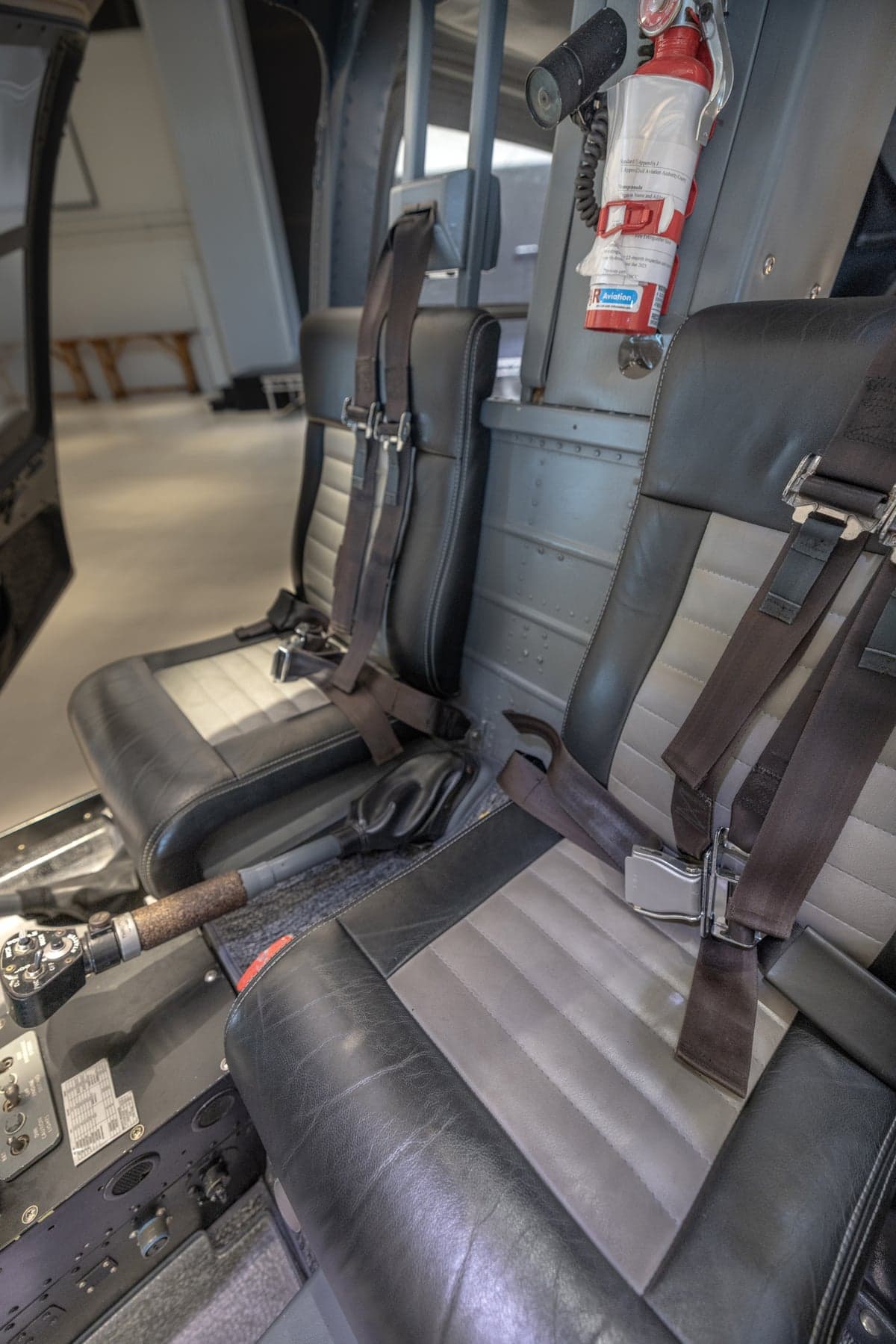 View of the interior of a helicopter, showing the seats and headphones.