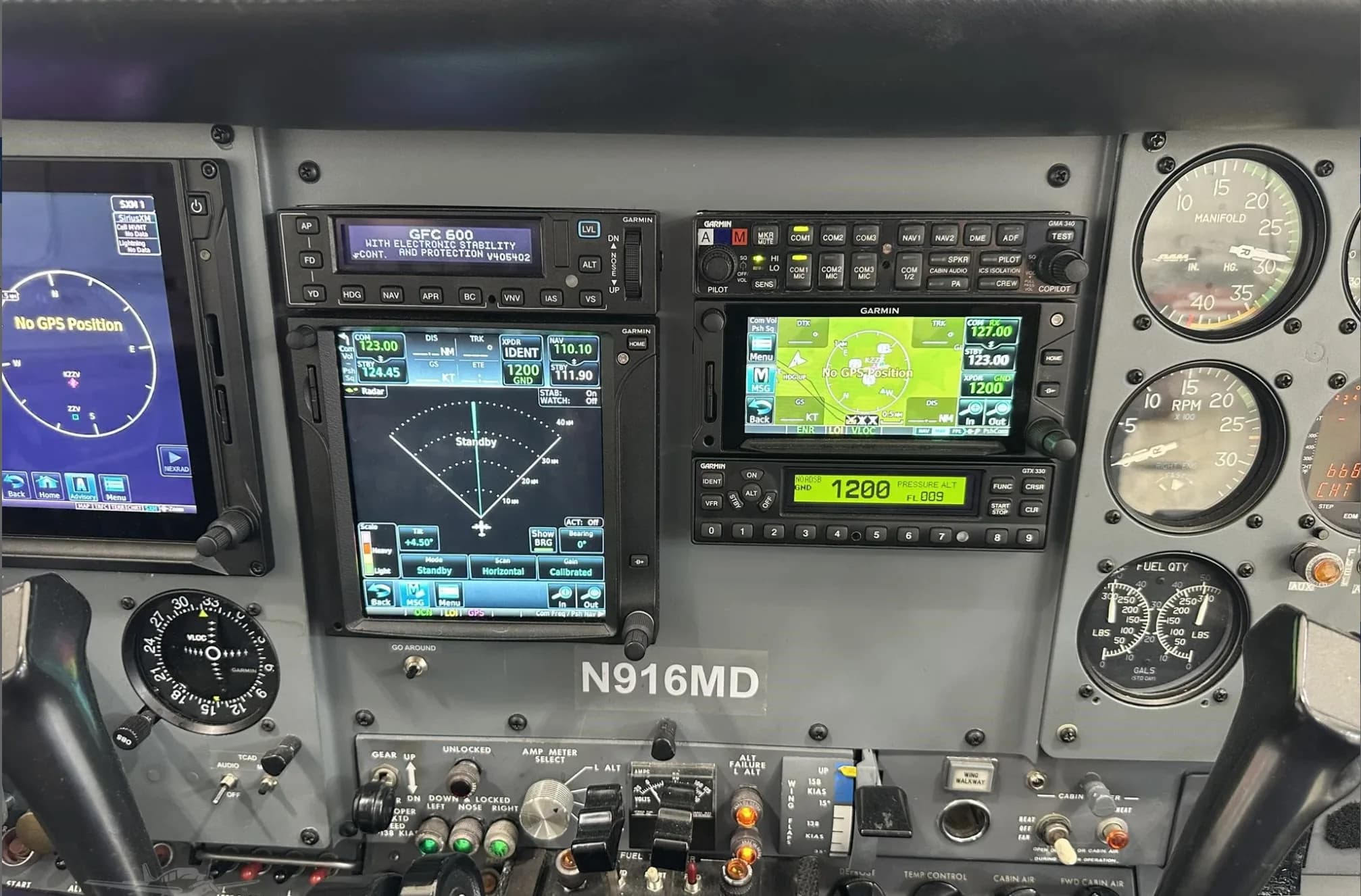 A wide view of the N916MD cockpit's instrument panel, showing various avionics, gauges, and controls.