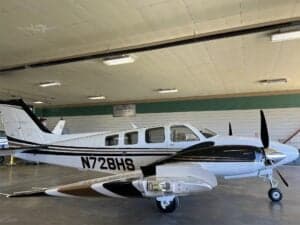 N728HS aircraft parked inside a hangar.