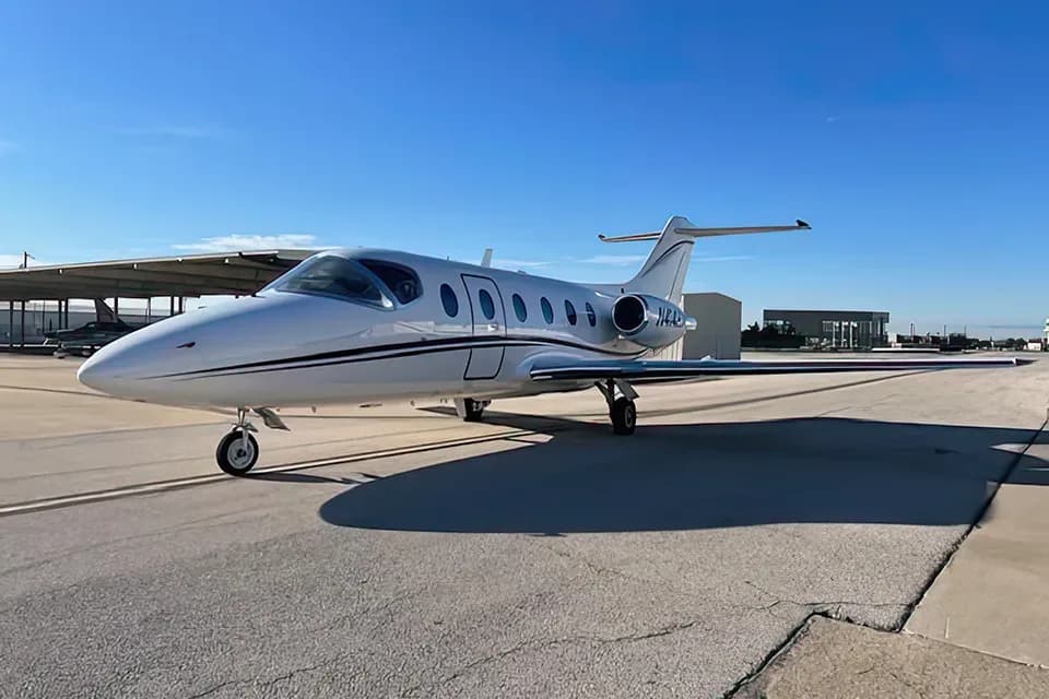 A Cessna Citation jet with a white paint scheme parked on the tarmac.