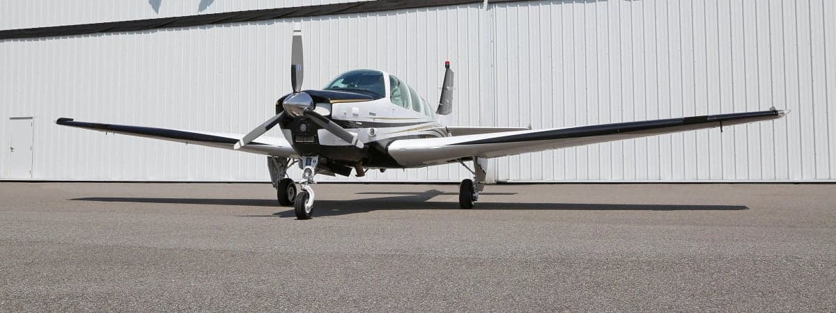 Front view of a Beechcraft Bonanza aircraft on the tarmac.