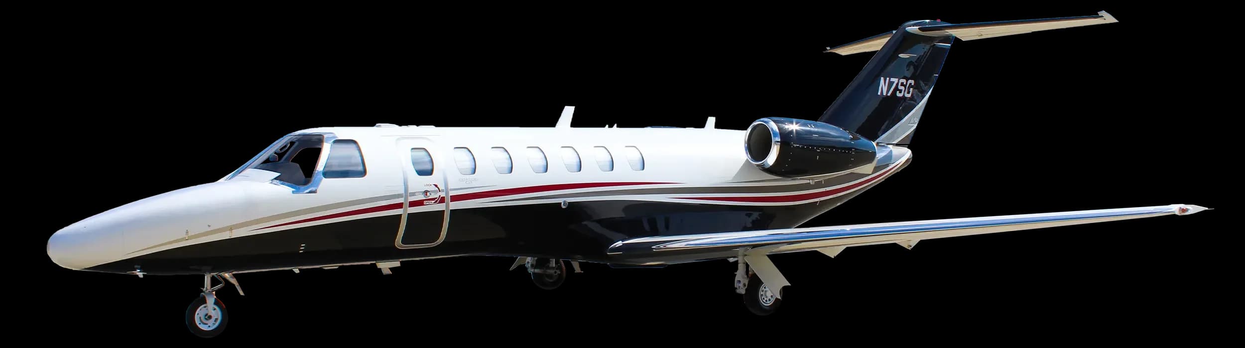 A white and black private jet with red and grey stripes, registration N7SG, viewed from the front-right.