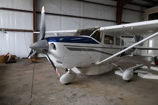 A turboprop aircraft parked inside a hangar.