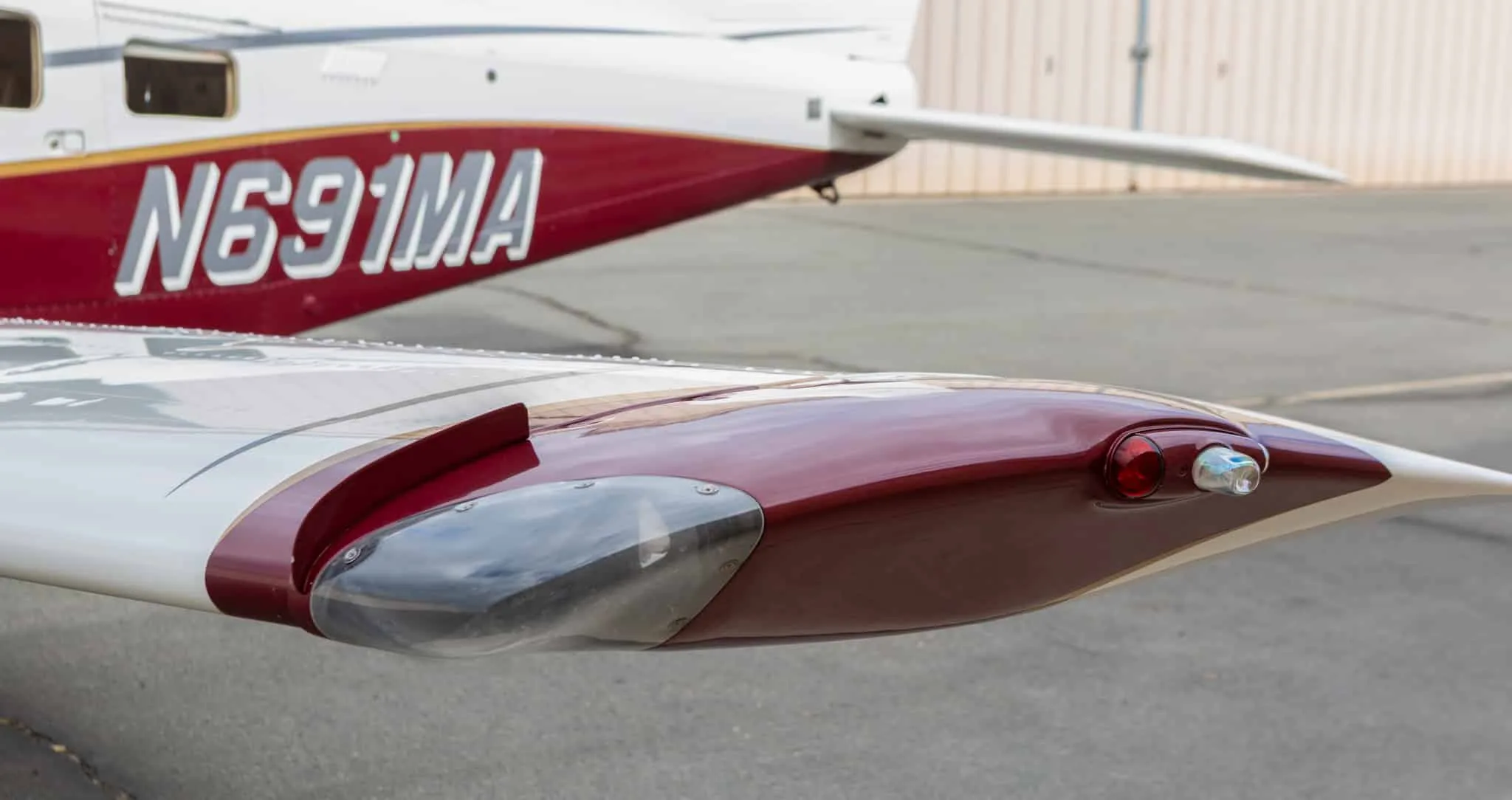 Close-up view of the wingtip and fuselage with registration N691MA on the Piper Saratoga II TC aircraft.