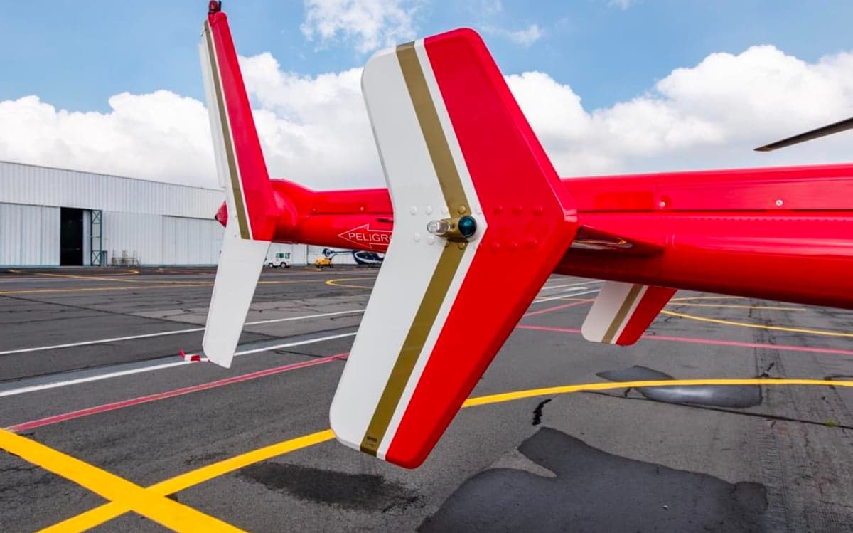 Close up of the tail section of the red and white helicopter.