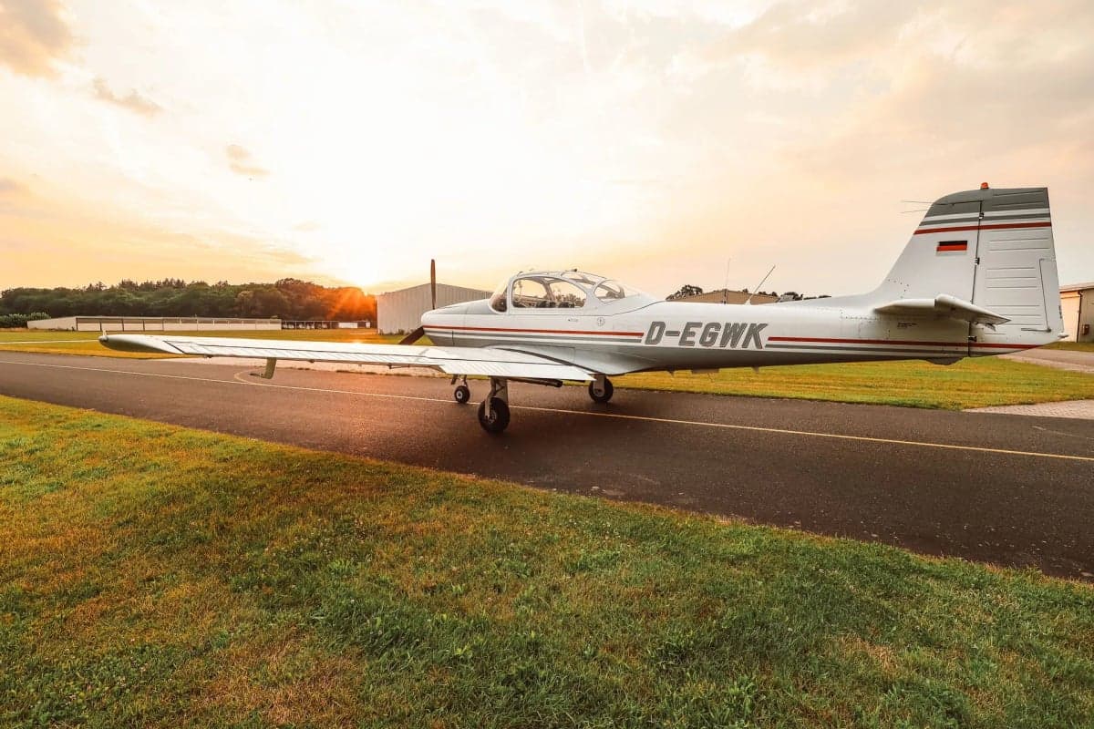 The D-EGWK aircraft is parked on the runway with a gray and white paint scheme.