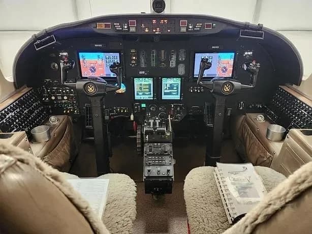 The aircraft's cockpit features a modern glass panel display and dual control yokes.