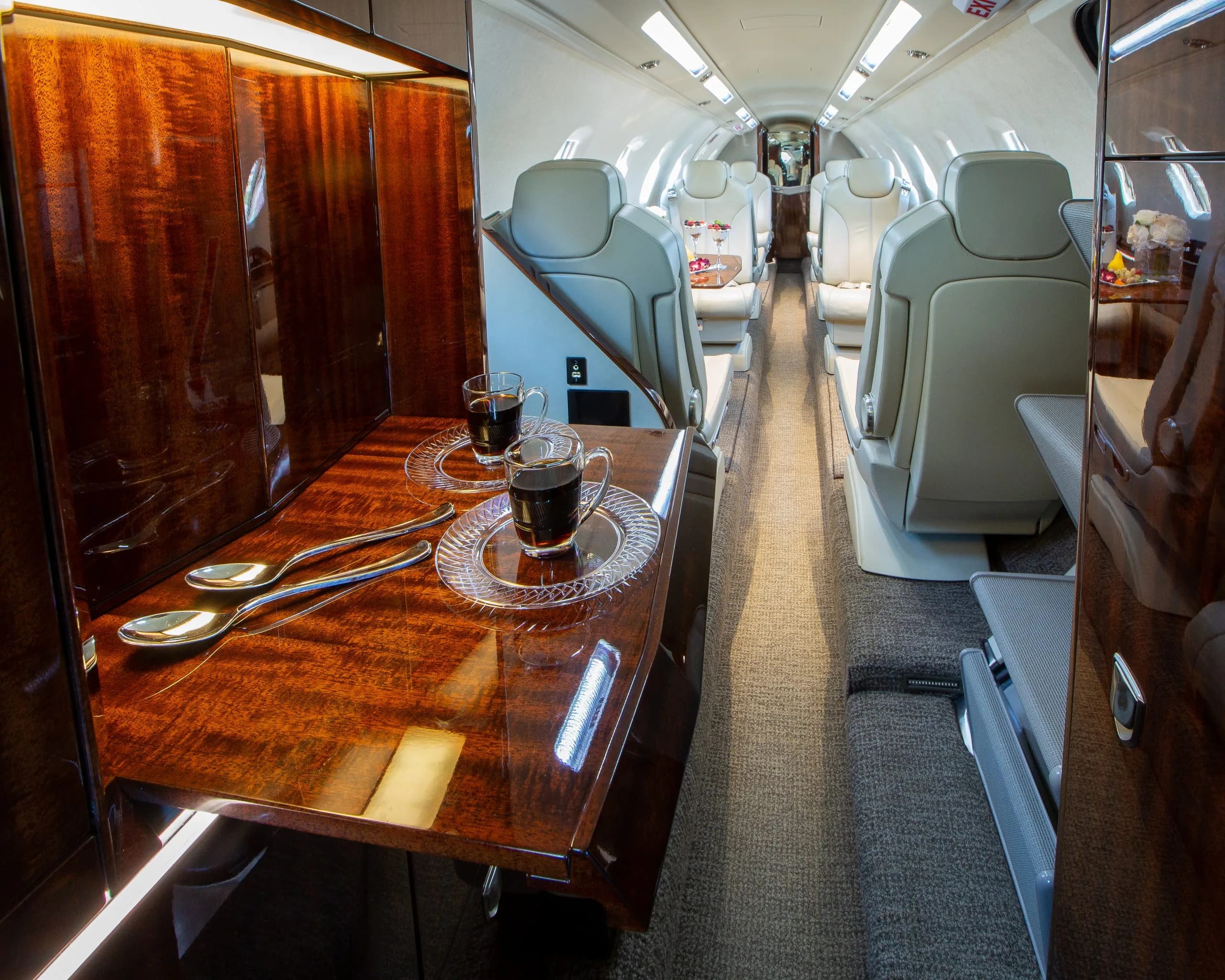 A view of the Citation CJ4 aircraft's interior, showcasing the seating and table.