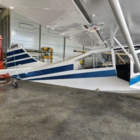 Tail section of a white and blue aircraft with registration C-GOPG.