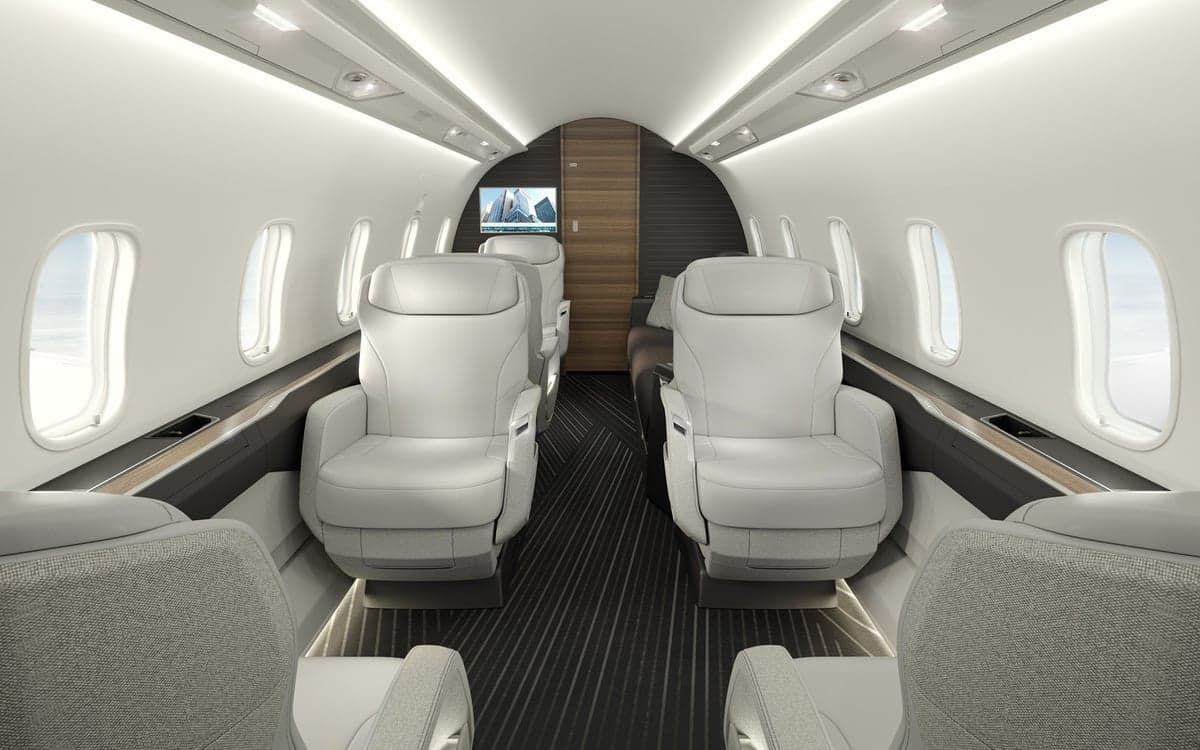 A view of the Challenger 3500 cabin with white leather seats.