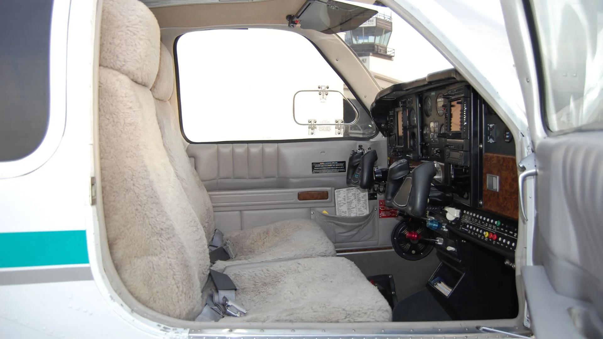 The cockpit of the Beechcraft Bonanza, showing the instrument panel, seats, and controls.