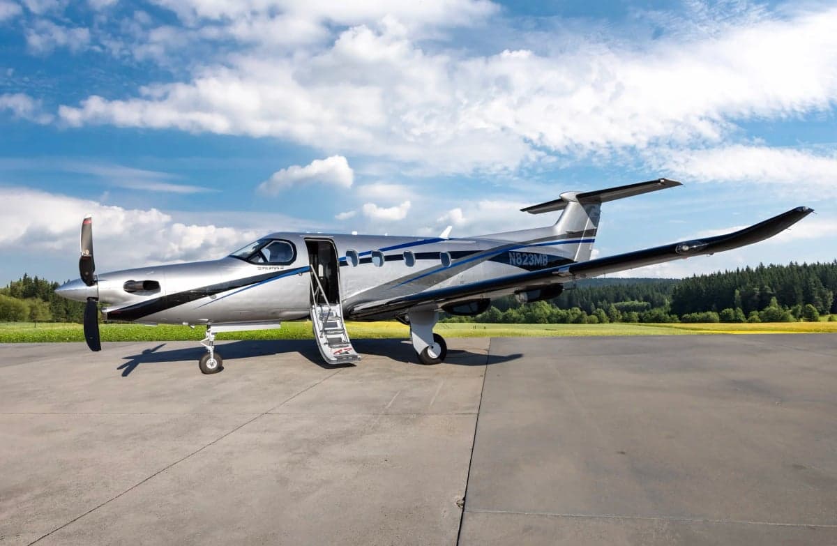 Pilatus PC-12NG with the door and stairs open on the tarmac.