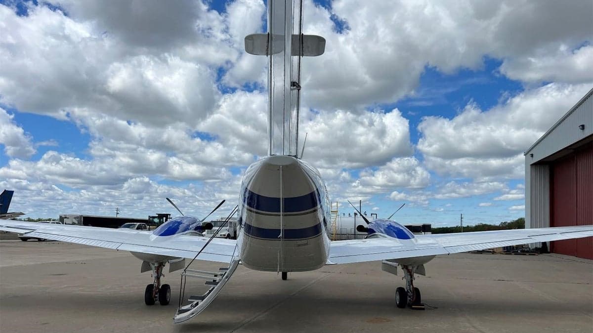 Rear view of a Beechcraft King Air with blue and white paint scheme.
