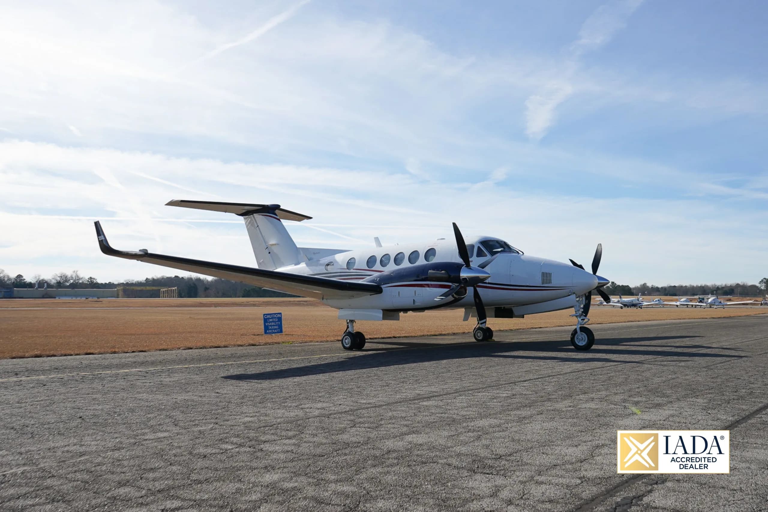 Beechcraft King Air 250 on the tarmac with a blue sky background.