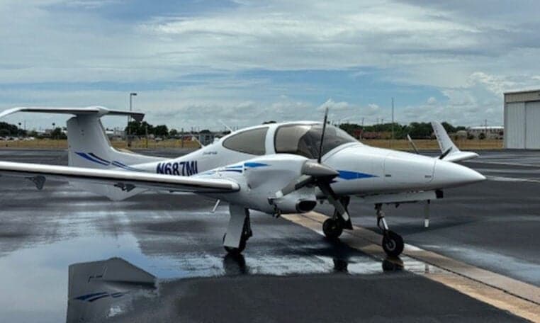 Diamond DA42-NG aircraft N687ML on the tarmac with reflection.