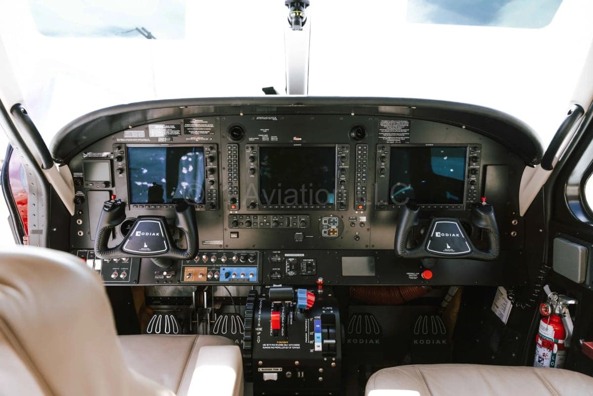 The cockpit of the Kodiak aircraft, showing the instrument panel with multiple screens and controls.