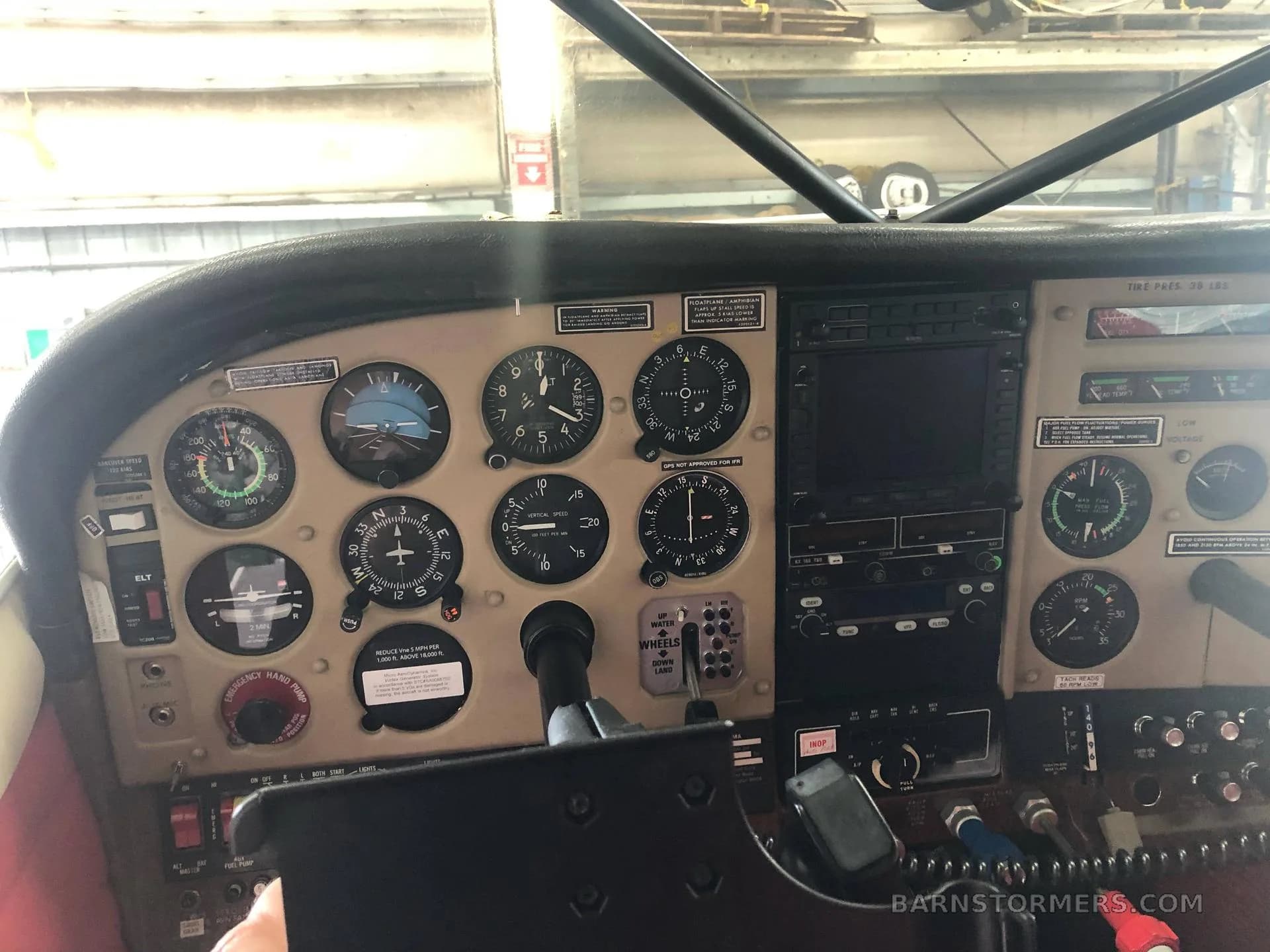 The instrument panel of a Cessna aircraft, featuring analog gauges and a modern GPS display.